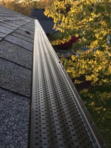 Perforated gutter guard installed over a seamless gutter in the Seattle Tacoma area