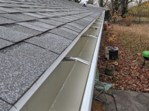 New seamless aluminum gutter along a shingle roof edge in the Seattle Tacoma area