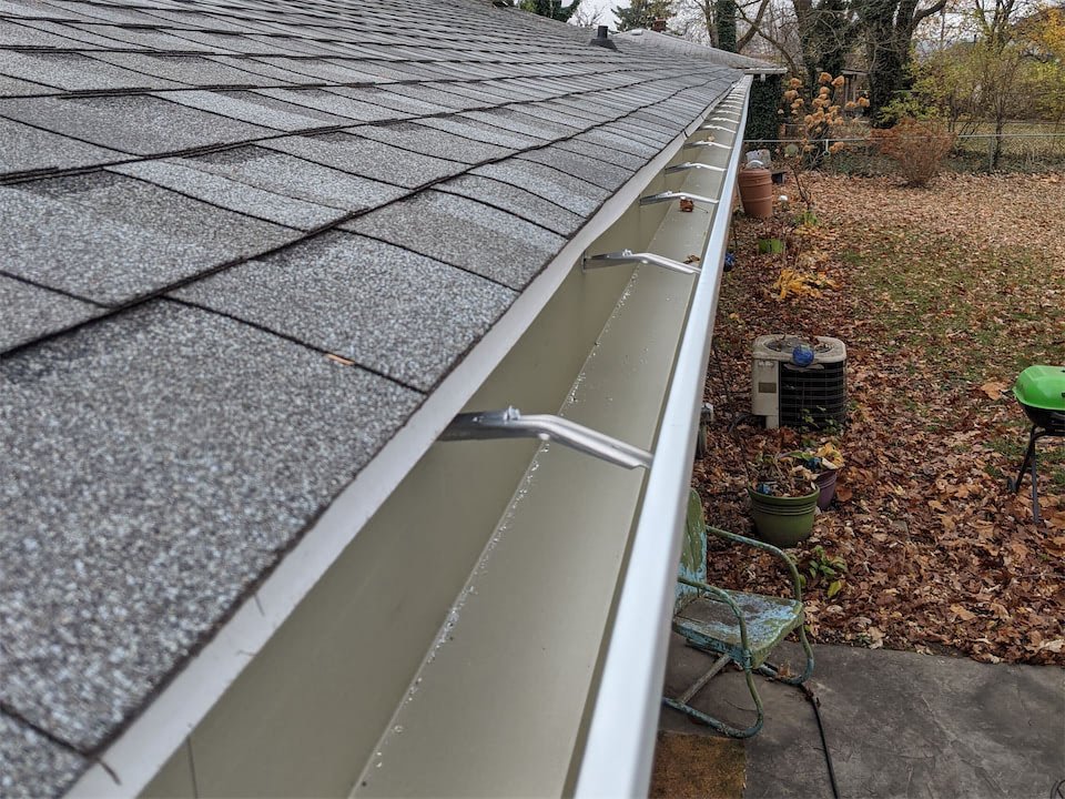 New seamless aluminum gutter with hidden hangers along a shingle roof in the Seattle Tacoma area | All Season Continuous Gutters & Roof Care