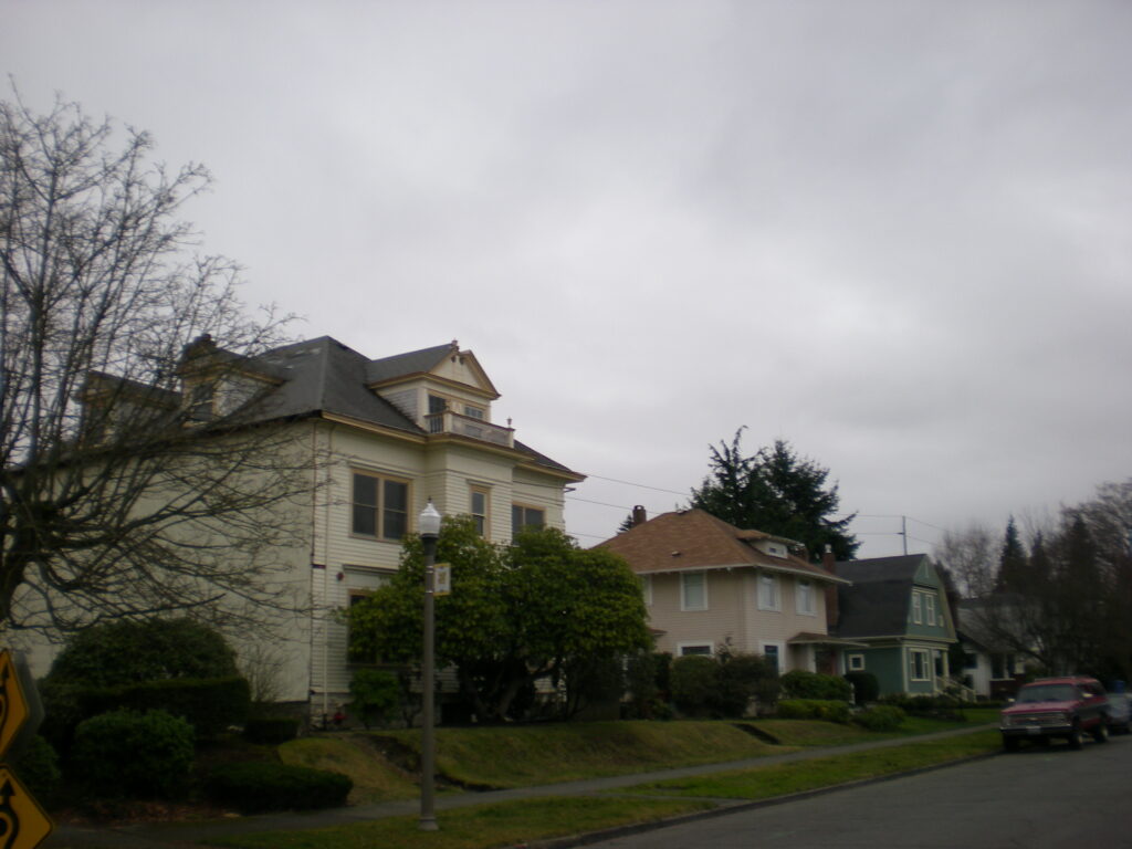 Older homes under mature trees in Tacoma's North Slope Historic District on an overcast day